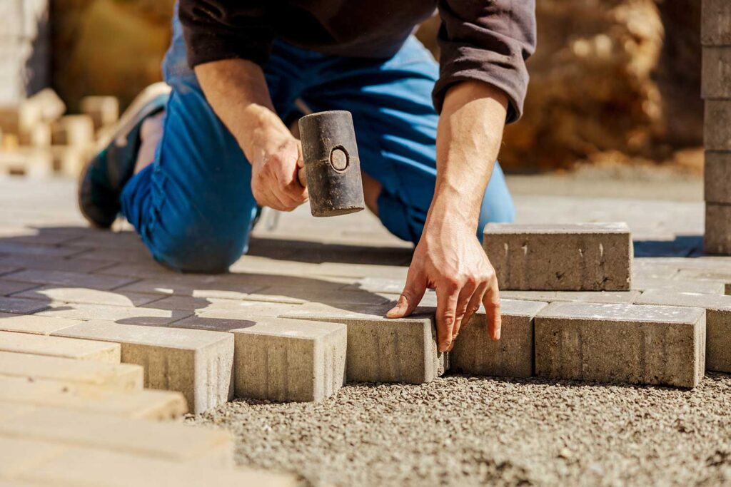 landscaper installing patio hardscape